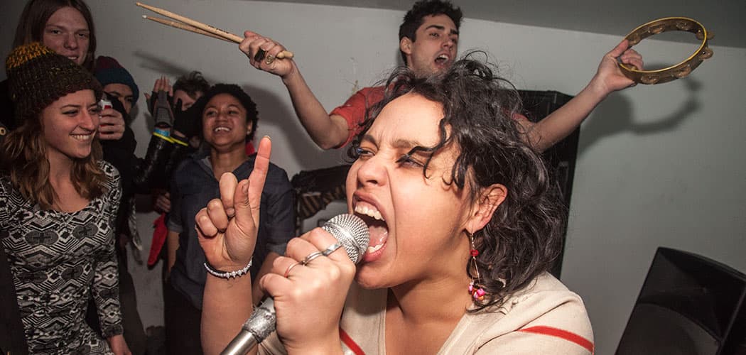 The Malportado Kids—Victoria Ruiz sings while Joey DeFrancesco (background) adds percussion. (Courtesy)
