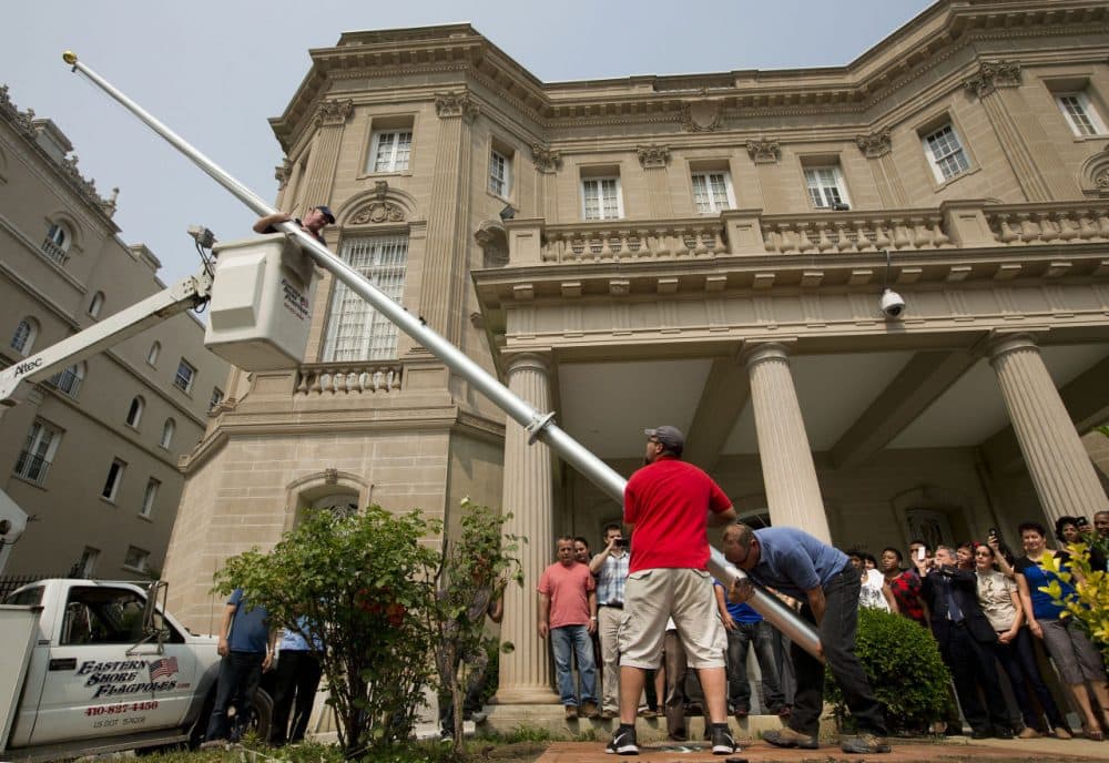 Workers from Eastern Shores Flagpoles raise a flagpole at the Cuban Interest Section in Washington in preparation for re-opening of embassies in Havana and Washington, Wednesday, June 10, 2015. (Pablo Martinez Monsivais/AP)