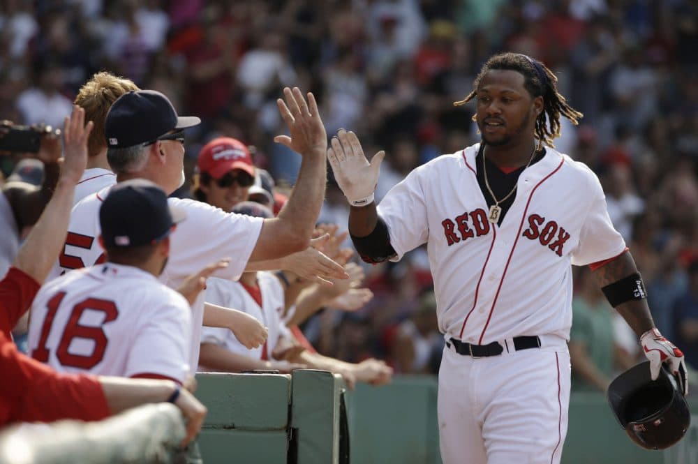 The Red Sox's Hanley Ramirez is welcomed to the dugout after hitting a two-run homer in the seventh inning of a game against the Houston Astros at Fenway Park on Sunday.  (Steven Senne/AP)