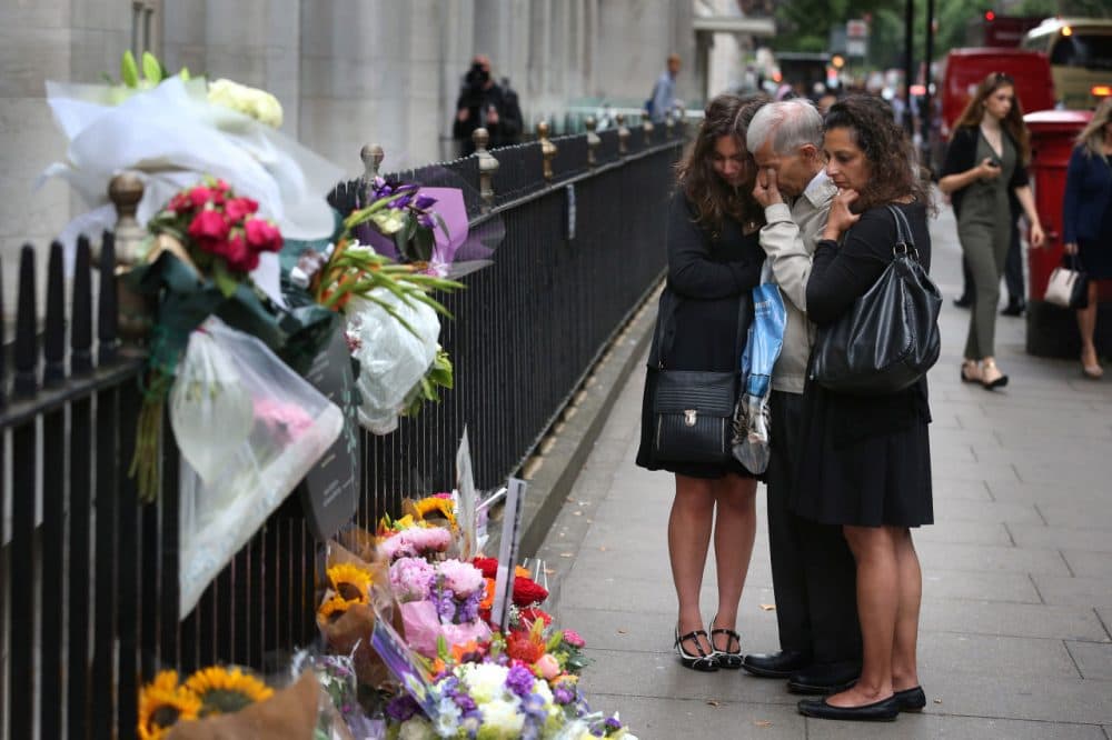 A family grieve as they stand next to a memorial to victims of the July, 2005 bus bombing near Tavistock Square on July 7, 2015 in London, England. Today is the tenth anniversary of the 7/7 bombings, when four suicide bombers struck transport system in central London on Thursday 7 July 2005, killing 52 people and injuring more than 770 in simultaneous attacks. (Peter Macdiarmid/Getty Images)