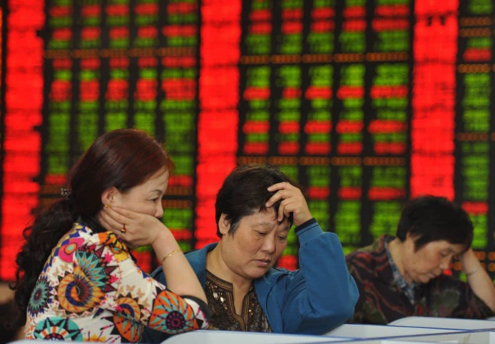 Investors check share prices in a stock firm in Fuyang, east China's Anhui province on June 29, 2015. Chinese shares plunged in morning trading on June 29, extending losses from the past two weeks despite a surprise interest rate cut at the weekend. (STR/AFP/Getty Images)
