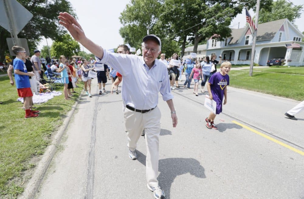 Democratic presidential candidate Sen. Bernie Sanders greets local residents in a Fourth of July parade in Waukee, Iowa. (Charlie Neibergall/AP)