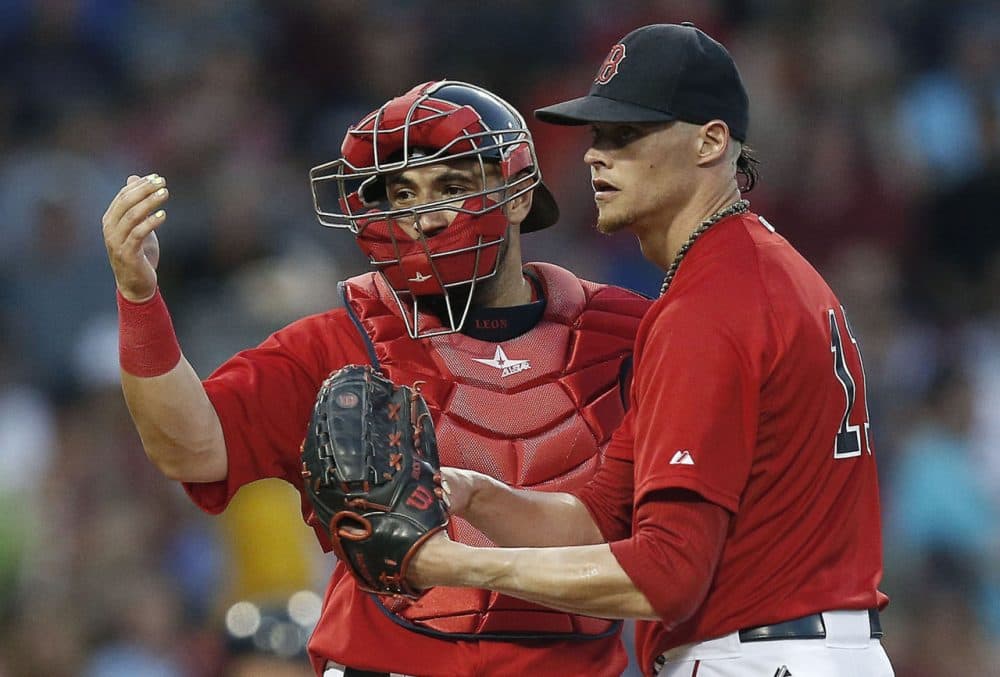 Boston Red Sox's Sandy Leon, left, signals to the dugout beside Clay Buchholz during the fourth inning. (AP Photo/Michael Dwyer)