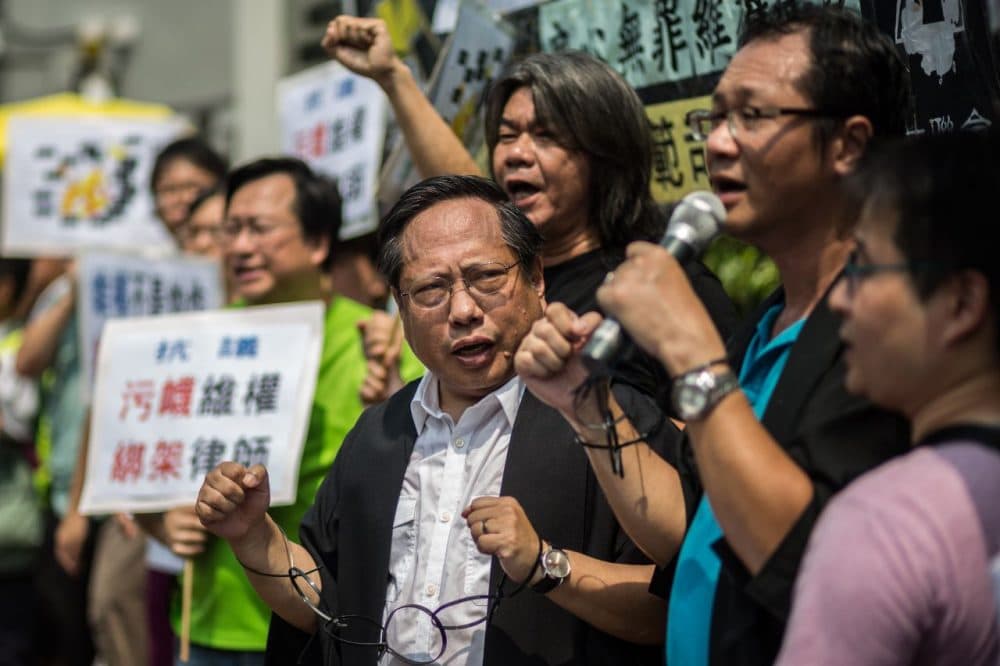 Hong Kong Democratic Party's Albert Ho and legislator Leung Kwok-hung, attend a protest in Hong Kong after at least 50 Chinese human rights lawyers and activists were detained or questioned in recent days. (Anthony Wallace/AFP/Getty Images)