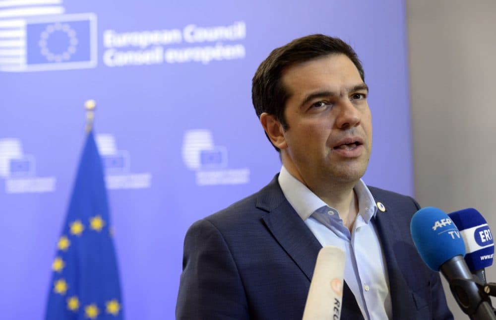 Greek Prime Minister Alexis Tsipras talks to the media at the end of an Eurozone Summit over the Greek debt crisis in Brussels on July 13, 2015. Juncker said there was no longer any risk of Greece crashing out of the euro after Athens agreed a bailout deal with eurozone partners.  (Theirry Charlier/Getty Images)