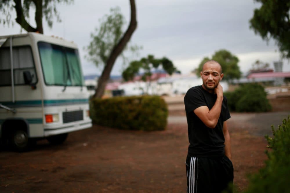 Terrance O'Neil, a former Staff Sgt. in the Marines,stands outside of his RV at a Trailer park aboard Camp Pendleton in Oceanside, Calif. on Dec. 2, 2014.  O'Neil was unexpectedly kicked out of Vitality College of Healing Arts and used his GI Bill money which was not refunded. (Sandy Huffaker for Reveal)