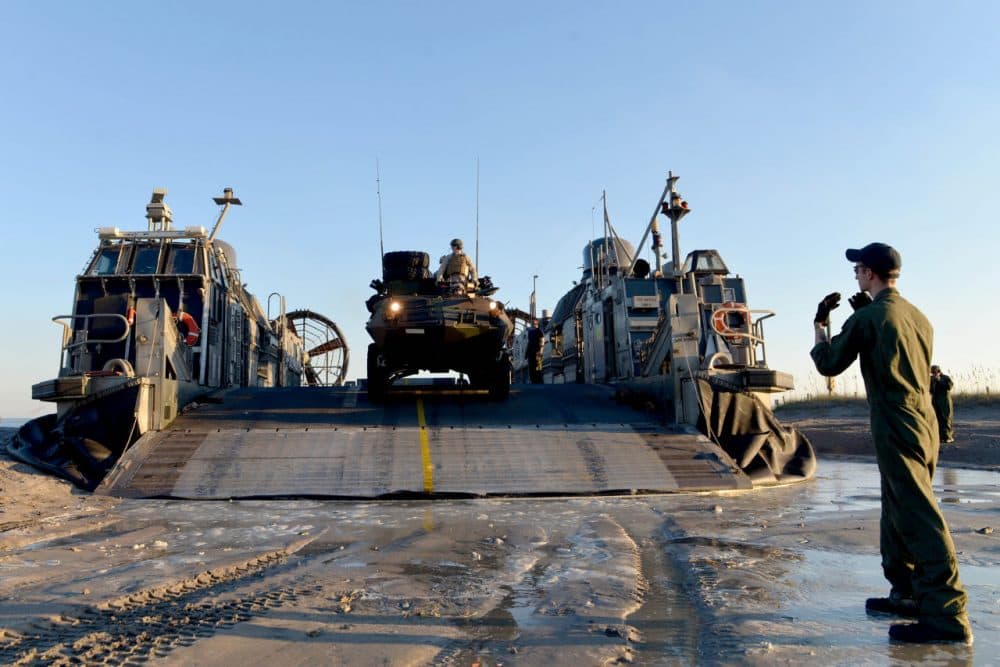 Marines unloading a light armored vehicle off a landing craft at Camp Lejeune, North Carolina. (U.S. Navy)
