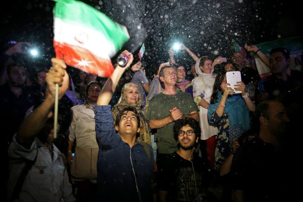 A group of jubilant Iranians cheer and spray artificial snow during street celebrations following a landmark nuclear deal, in Tehran, Iran, Tuesday, July 14, 2015. After long, fractious negotiations, world powers and Iran struck an historic deal Tuesday to curb Iran's nuclear program in exchange for billions of dollars in relief from international sanctions - an agreement aimed at averting the threat of a nuclear-armed Iran and another U.S. military intervention in the Middle East. (Ebrahim Noroozi/AP)