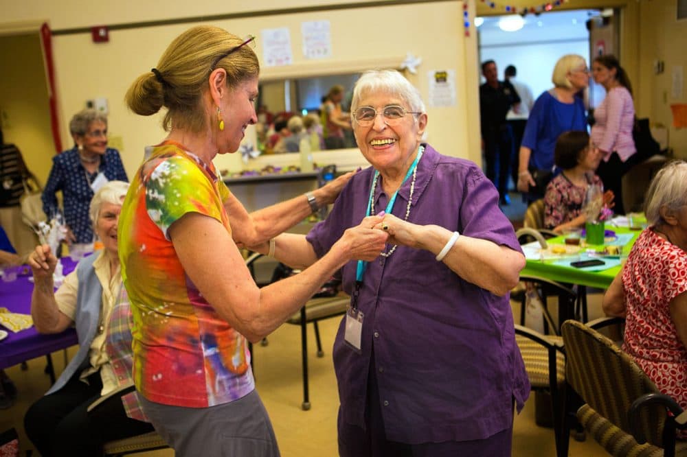 Ethel Weiss, 100, dances with her daughter Anita Jamieson at the “Party Of The Century” at the Brookline Senior Center. (Jesse Costa/WBUR)