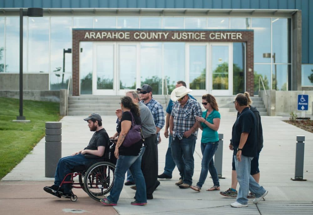 Shooting victim Caleb Medley (left) leaves the Arapahoe County Justice Center after a verdict was delivered in the trial of James Holmes on July 16, 2015 in Centennial, Colorado. Holmes was found guilty on all counts in the 2012 movie theater shooting in Aurora, Colorado. (Theo Stroomer/Getty Images)