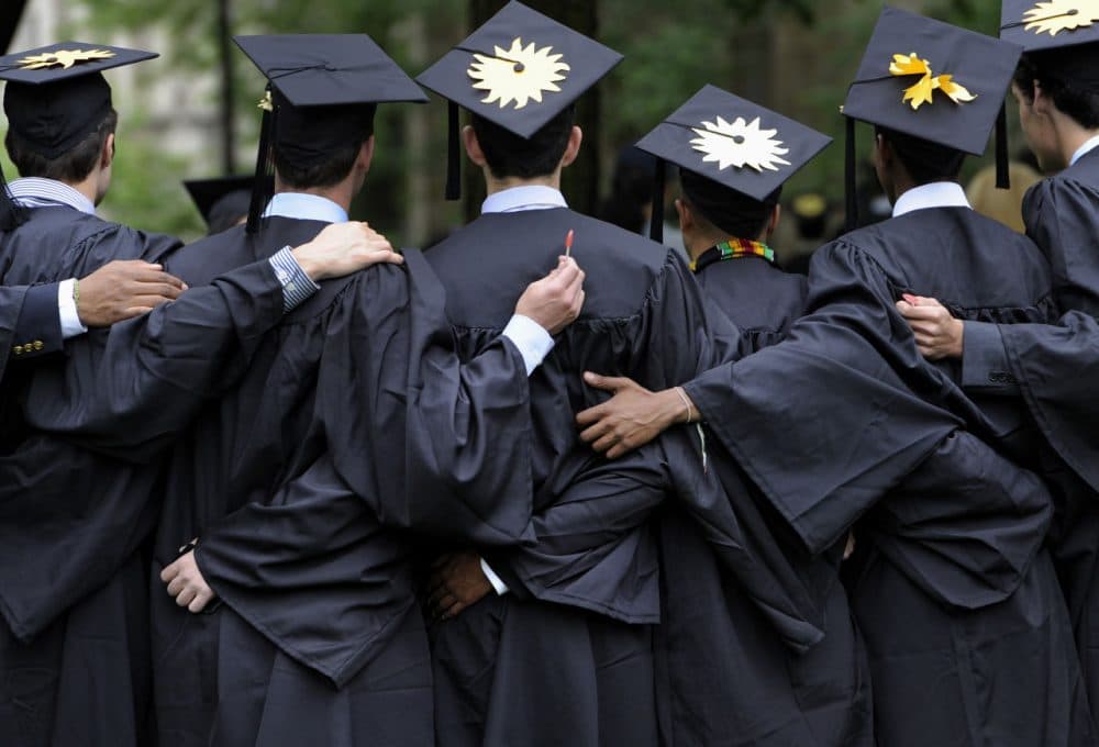 In this May 20, 2013 photo, graduates pose for photographs during commencement at Yale University in New Haven, Conn. (Jessica Hill/AP)