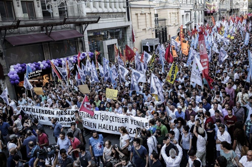 Protesters hold flags and a banner reading 'Islamic state gangs will lose, our resisting people will win' during a demonstration on July 20, 2015 in Istiklal avenue in Istanbul, after a suicide bombing in the Turkish town of Suruc near the border with Syria killed 32 people. (Yasin Akgul/AFP/Getty Images)