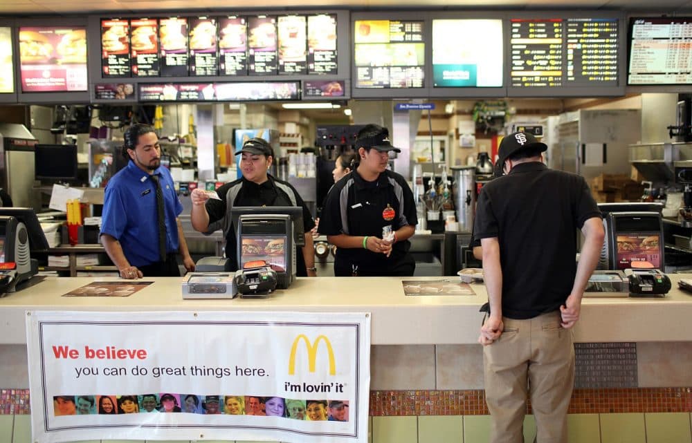 McDonald's employees wait to take orders during a one-day hiring event at a McDonald's restaurant on April 19, 2011 in San Francisco, California. (Justin Sullivan/Getty Images)