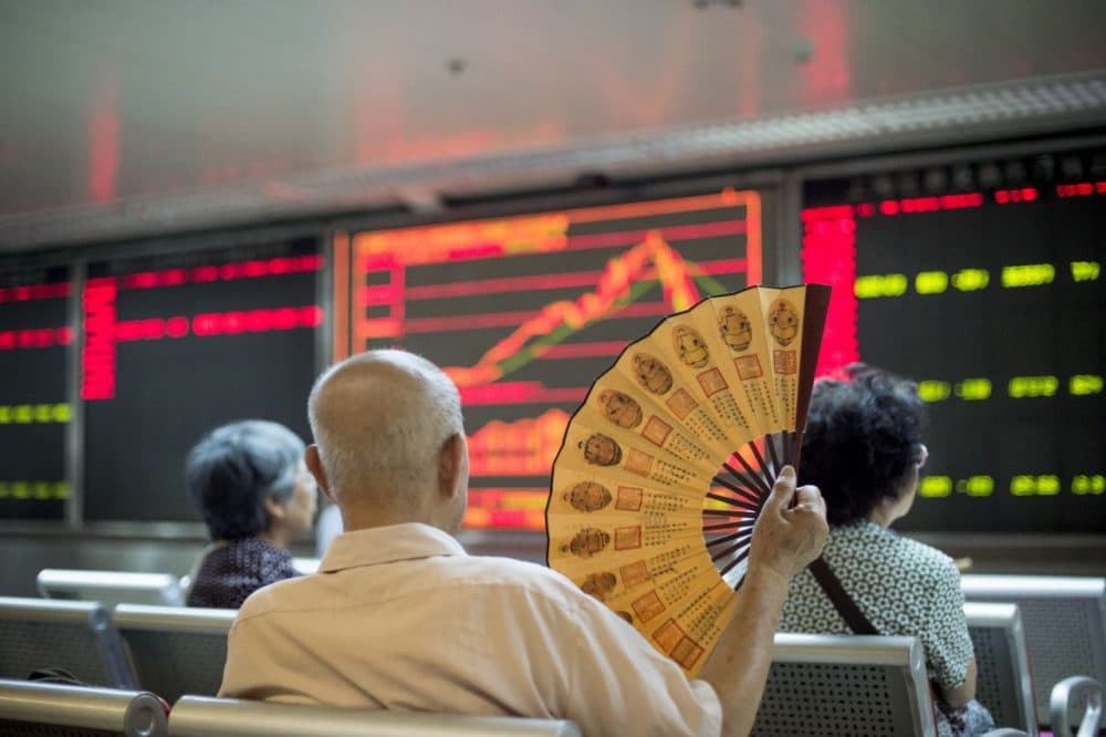Investors look at screens showing stock market movements at a securities company in Beijing on July 28, 2015. Chinese shares sank on July 28, a day after Shanghai's steepest one-day slide in eight years, defying renewed government vows of support that analysts warned were not enough to soothe nervous investors. (Fred Dufour/AFP/Getty Images)