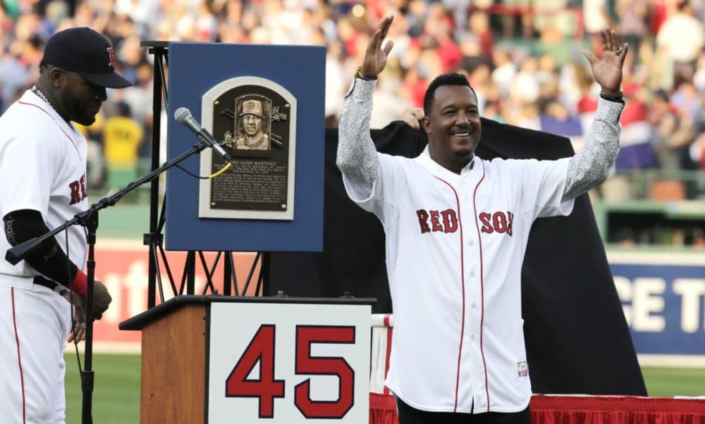 Boston Red Sox Hall of Fame pitcher Pedro Martinez raises his arms during a ceremony where his #45 was retired prior to a baseball game at Fenway Park in Boston, Tuesday. (Charles Krupa/AP)