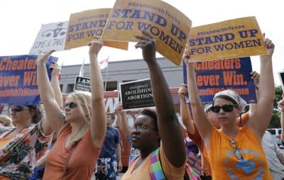 Opponents and supporters of an abortion bill hold signs outside the Texas Capitol on July 9 in Austin. (Eric Gay/AP)