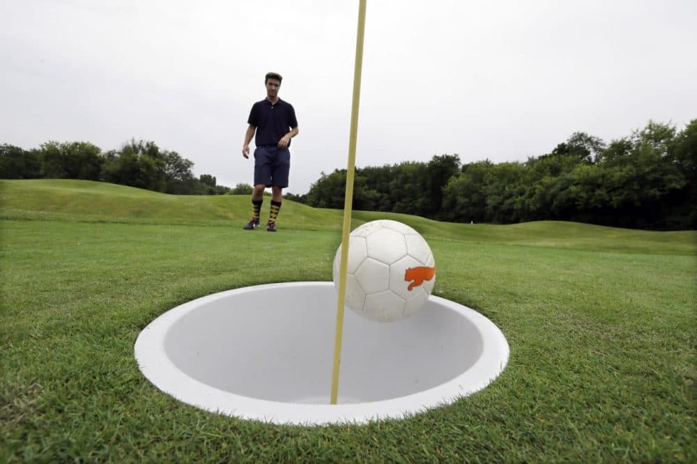 FootGolf is played on golf courses with slight modifications. Players kick regulation soccer balls into a 21-inch hole. (Carlos Osorio/AP)