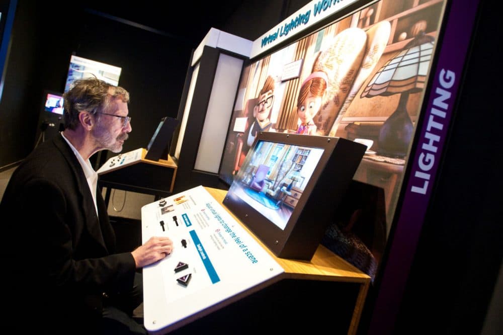 Ed Catmull, president of Walt Disney and Pixar Animation Studios, plays with an interactive lighting display in the Museum of Science exhibit &quot;The Science Behind Pixar.&quot; (Courtesy Ashley McCabe)