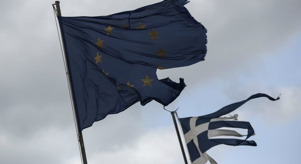 Alex Green: &quot;Unless the structure of the Eurozone is changed, similar crises will tend in the same direction, and if that is the case, the question arises: What is a government for?&quot;
Pictured: Ruined EU and Greek flags fly in tatters from a flag pole at a beach at Anavissos village, southwest of Athens. (Yorgos Karahalis/AP)