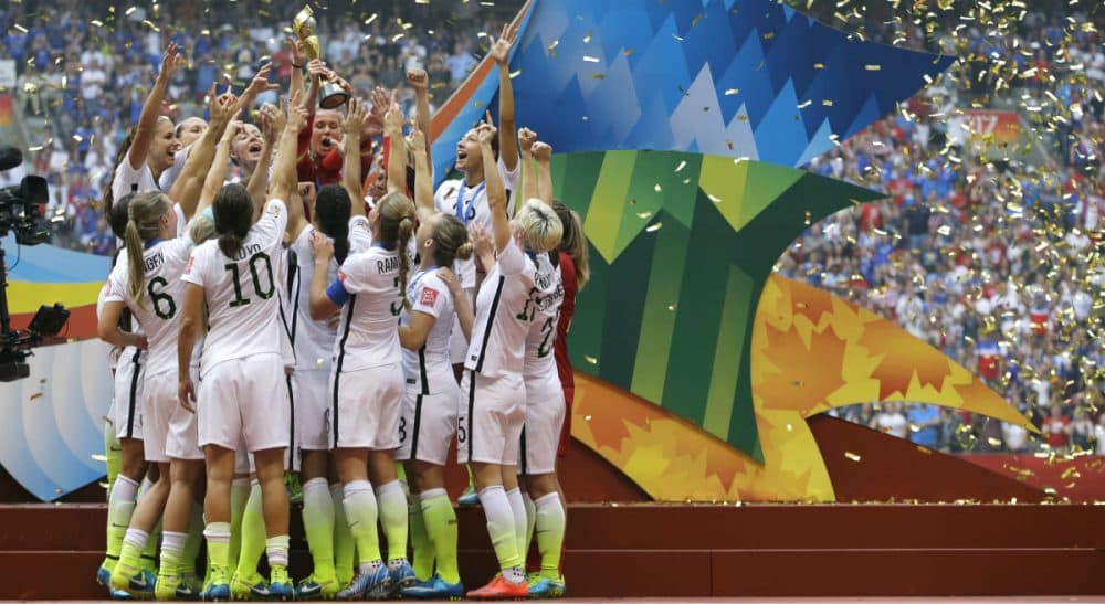 The United States Women's National Team celebrates with the trophy as confetti falls after they beat Japan 5-2 in the FIFA Women's World Cup soccer championship in Vancouver, British Columbia, Canada, Sunday, July 5, 2015. (Elaine Thompson/AP)
