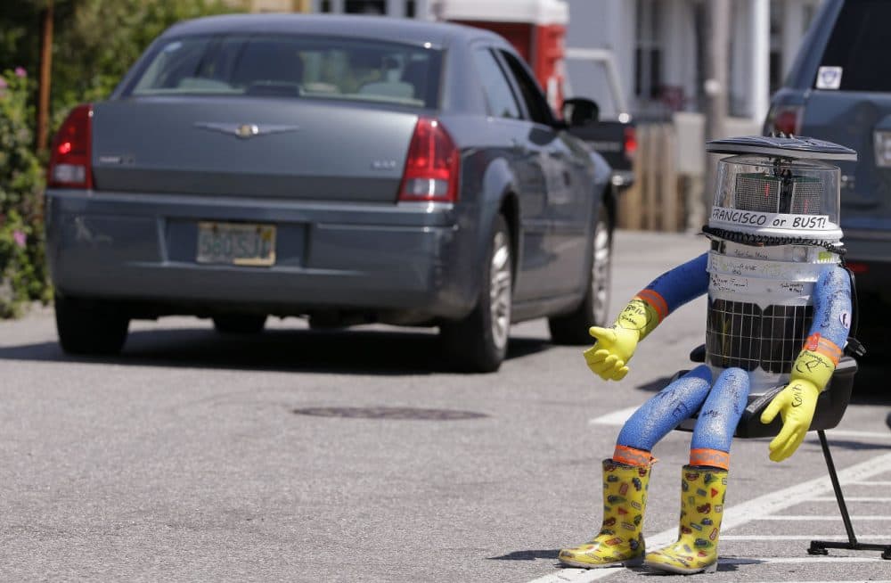 HitchBOT started in Marblehead, Massachusetts, on July 17 with its thumb raised skyward, a grin on its digital face and tape wrapped around its head that read “San Francisco or bust.” (Stephan Savoia/AP)