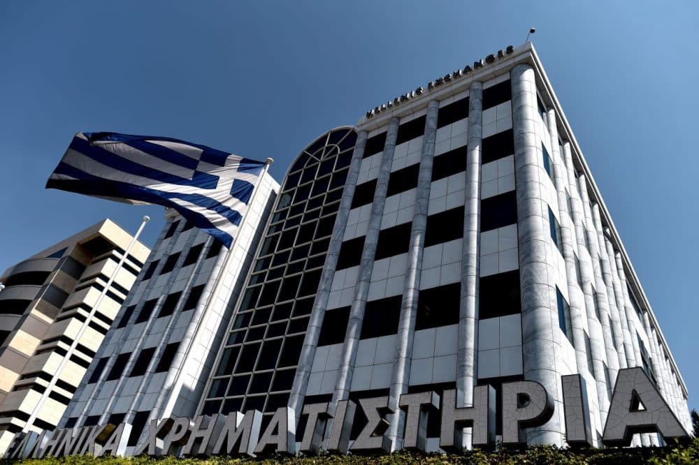 A Greek flag waves outside the Athens Stock Exchange on Aug. 3, 2015 when the market reopened after a five-week closure. (Aris Messinis/AFP/Getty Images)