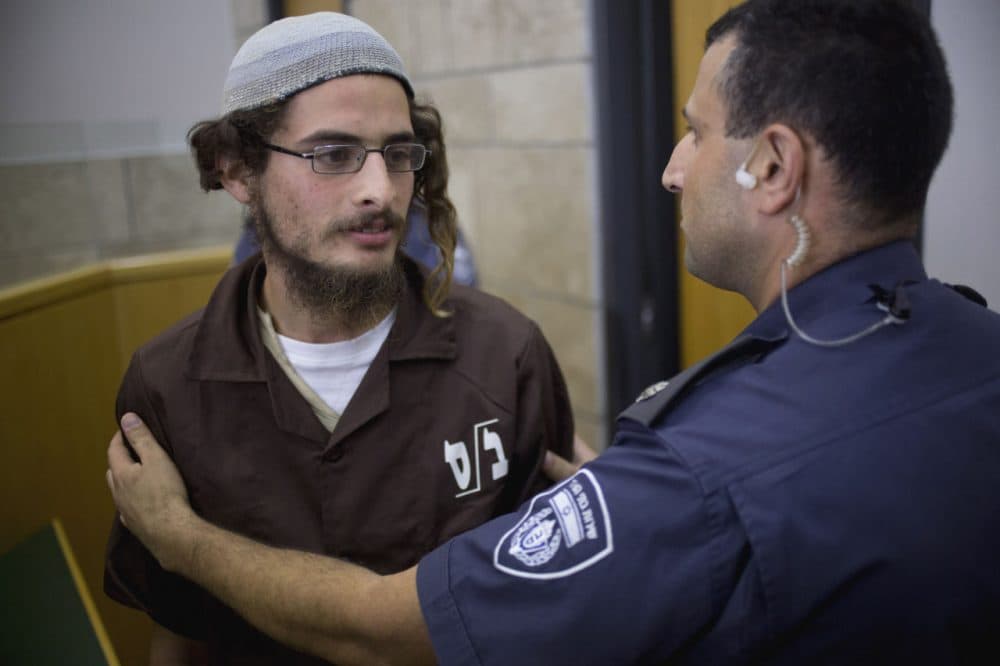 Meir Ettinger appears in court in Nazareth Illit, Israel, on Tuesday, Aug. 4, 2015. Israel said Tuesday it was interrogating  Ettinger, the suspected head of a Jewish extremist group, in the first arrest of an Israeli suspect following last week's arson attack in the West Bank that killed a Palestinian toddler and wounded his brother and parents. (Ariel Schalit/AP)