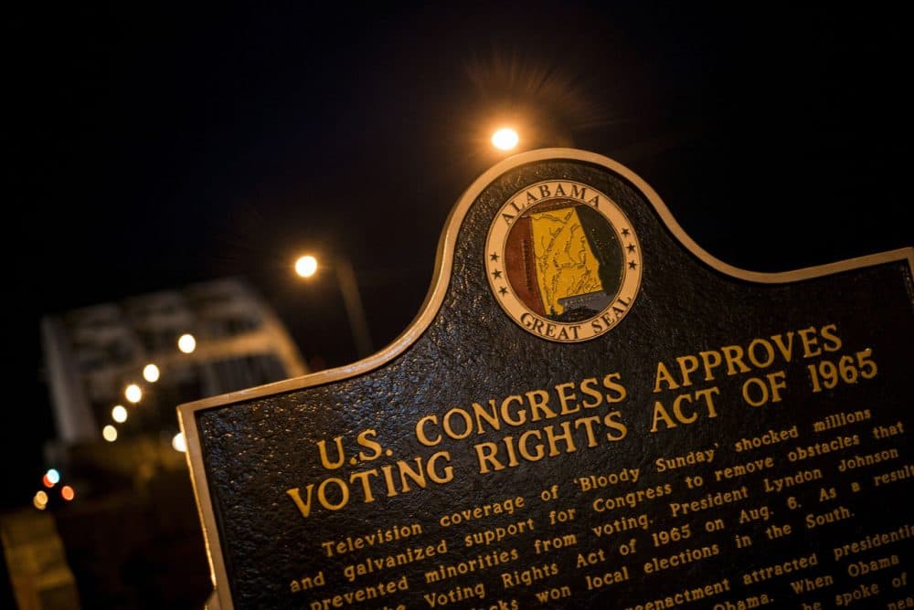 A plaque describes the 1965 Voting Rights Act at the base of the Edmund Pettus Bridge, where route 80 crosses the Alabama River, on March 4, 2015 in Selma, Alabama. (Brendan Smialowski/AFP/Getty Images)