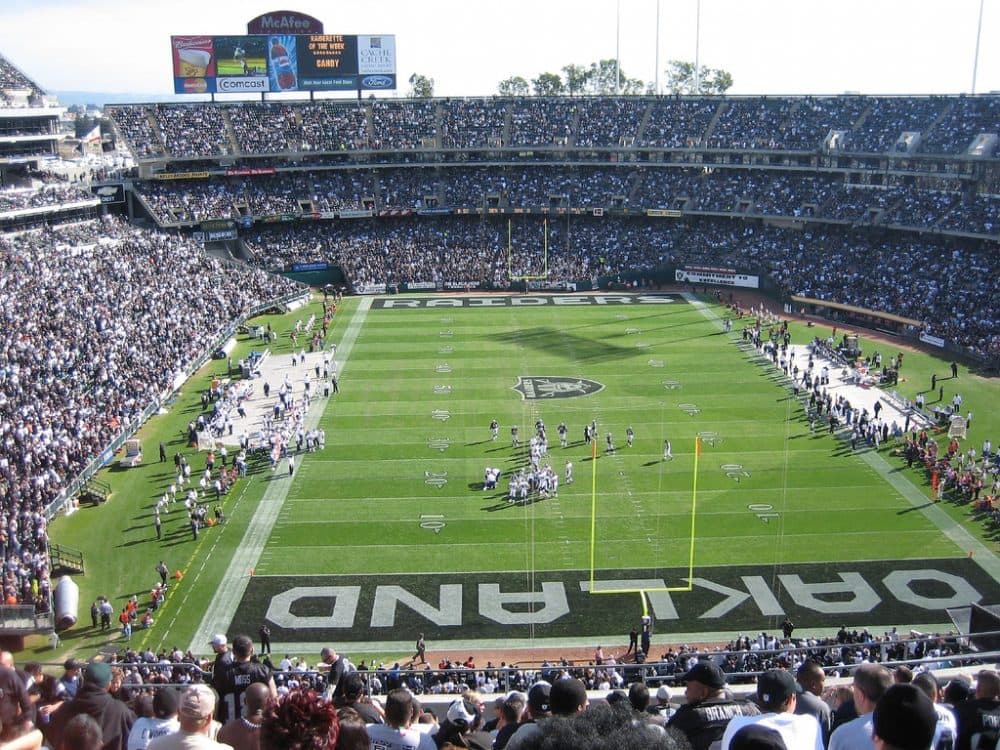 The Oakland Raiders are among three NFL teams with proposals on the table for new stadiums. But do professional sports stadiums help or hurt their neighborhoods? (Chris Yunker/Flickr)