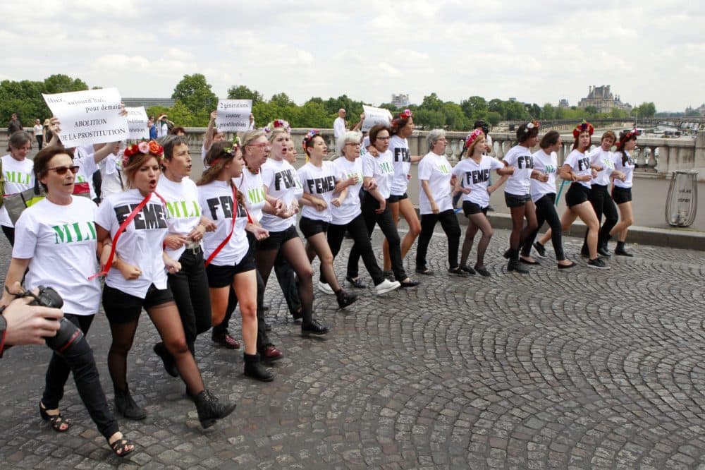 Femen activists chanting slogans and carrying signs reading: Abolition of Prostitution, No Demand No Offer, walk towards the French National Assembly in Paris on June 12 as part of a demonstration asking for the abolition of prostitution. (Remy de la Mauviniere/AP)