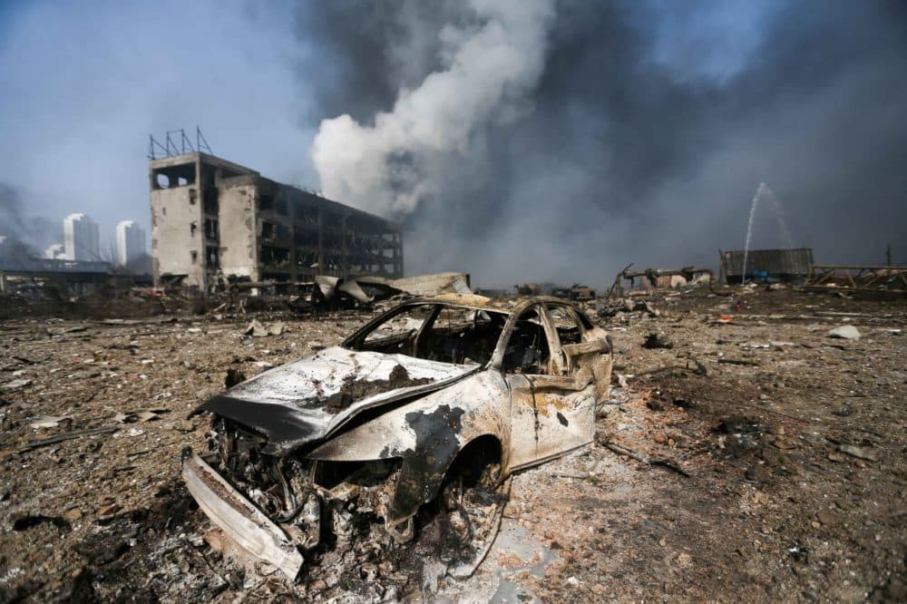 A damaged car is seen at the site of the massive explosions in Tianjin, China today. Enormous explosions in the port city killed at least 44 people and injured more than 500, state media reported, leaving a devastated industrial landscape of incinerated cars, toppled shipping containers and burnt-out buildings. (STR/Getty Images)