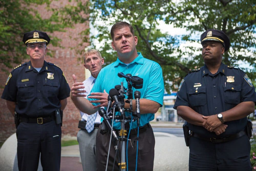 Boston Mayor Marty Walsh speaks Thursday in Roxbury about shootings that left three dead in the city. He's flanked by Boston Police Department officials.  (Jesse Costa/WBUR)