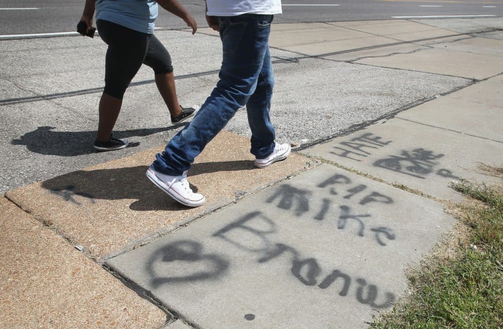Graffiti remains on the sidewalk along West Florrisant Avenue one year after the shooting of Michael Brown one year ago. Brown was shot and killed by a Ferguson police officer on August 9, 2014. (Scott Olson/Getty Images)