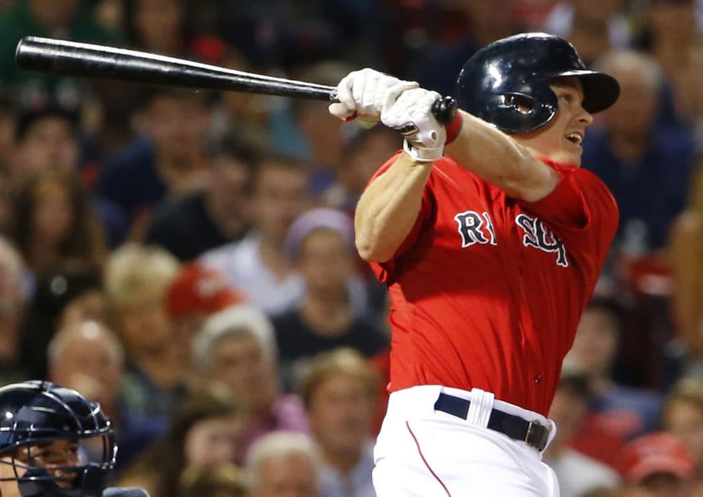Boston Red Sox's Brock Holt watches his two-run triple against the Seattle Mariners during the third inning at Fenway on Aug. 14, 2015. (Winslow Townson/AP)