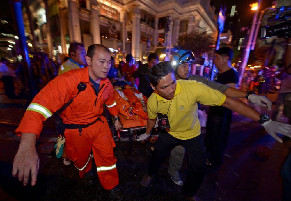 Rescue workers carry an injured person after a bomb exploded outside a religious shrine in central Bangkok late on August 17, 2015. (Pornchai Kittiwongsakul/AFP/Getty Images)