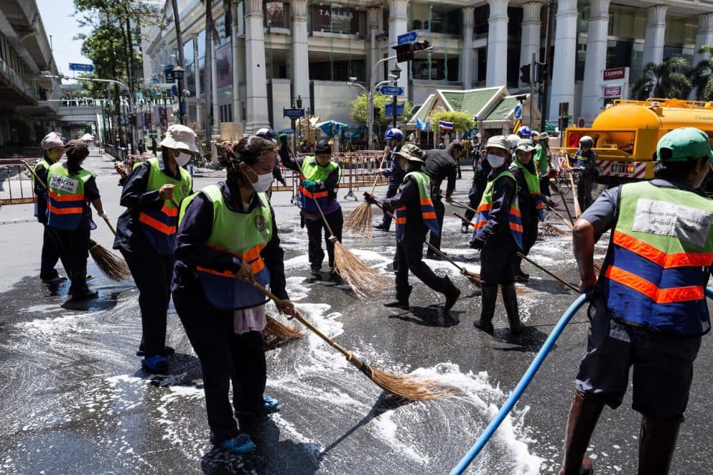 Workers clean up debris from the site of the explosion on August 18, 2015 in Bangkok, Thailand. Last night a bomb explosion in the centre of Bangkok, which went off next to the Erawan Shrine killed at least 21 people and hundreds more injured. (Nicolas Axelrod/Getty Images