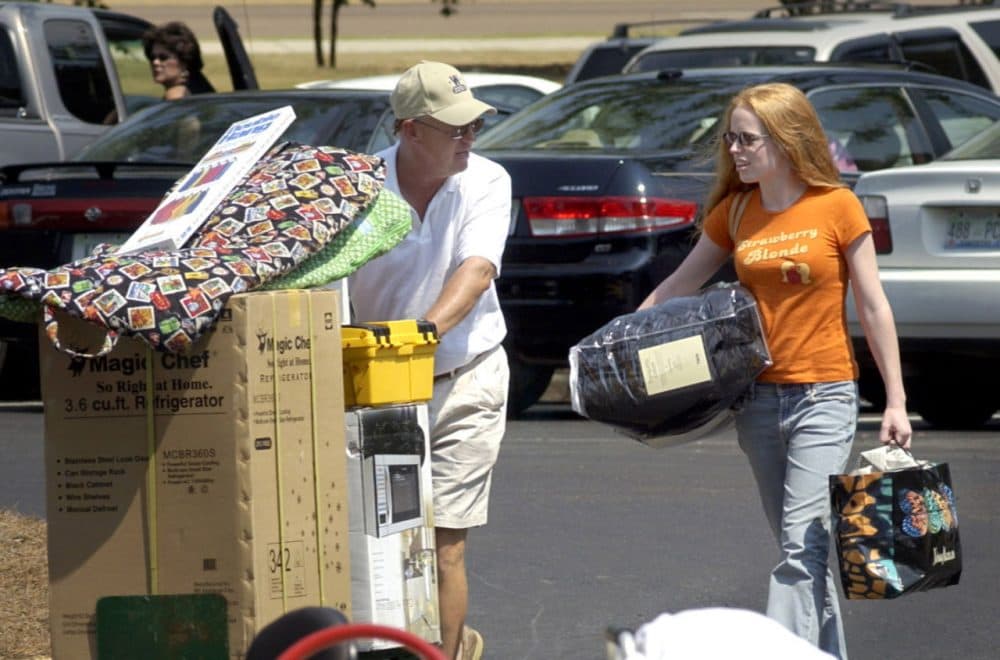 Duval McDaniel from Katy, Texas, helps his daughter, Darby, a then Ole Miss freshman, move into Stockard-Martin Hall on the Oxford campus of The University of Mississippi in this Aug.19, 2004, photo. (Kevin Bain/AP)
