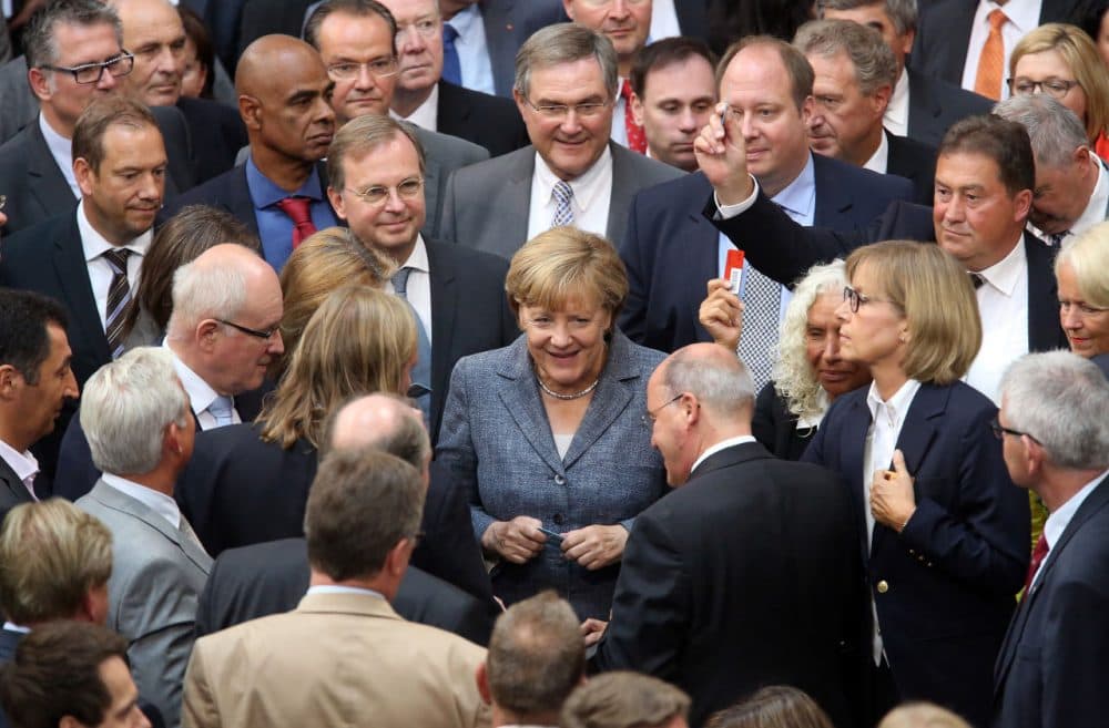 German Chancellor Angela Merkel casts her vote on a third bailout package for economically-troubled eurozone member Greece as she attends a meeting of the German federal parliament, or Bundestag, on August 19, 2015 in Berlin, Germany. (Adam Berry/Getty Images)