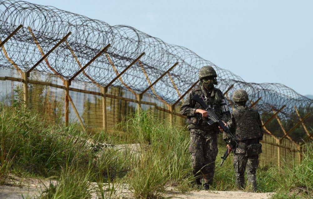 In this photo provided by the South Korean Defense Ministry on August 10, 2015, South Korean soldiers patrol near the scene where planted landmines exploded on August 4, maiming two soldiers on border patrol in the demilitarized zone dividing North and South Korea, on August 9, 2015 in Paju, South Korea. South Korea has accused North Korea of planting the landmines, sending military tensions on the Korean peninsula soaring as it threatened to make Pyongyang pay a 'harsh price.' (South Korean Defense Ministry via Getty Images)