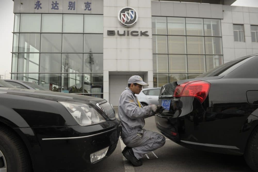 A mechanic works on a Buick at a General Motors dealership in Shanghai on December 6, 2011. (Peter Parks/AFP/Getty Images)