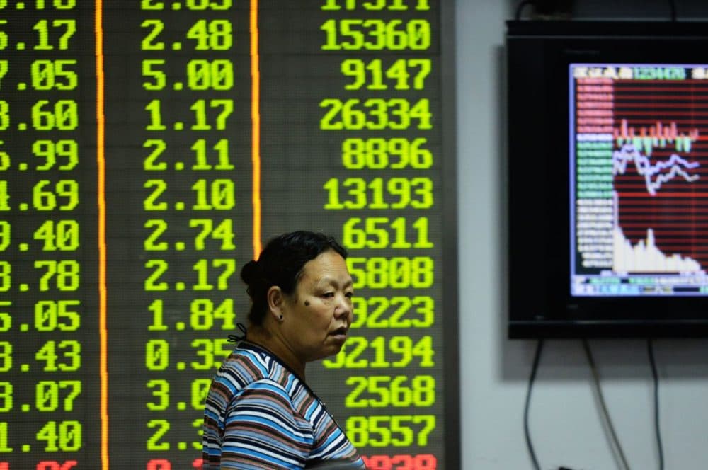 An investor observes the stock market at an exchange hall on August 21, 2015 in Hangzhou, Zhejiang Province of China. (ChinaFotoPress/Getty Images)