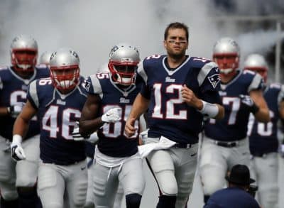 If you'd never let your own son play, but you're perfectly fine watching someone else's kid get thrashed, you're part of the problem. In this photo, New England Patriots quarterback Tom Brady leads his teammates onto the field before a game on Sunday, Sept. 21, 2014, in Foxborough, Mass. (Elise Amendola/ AP)
