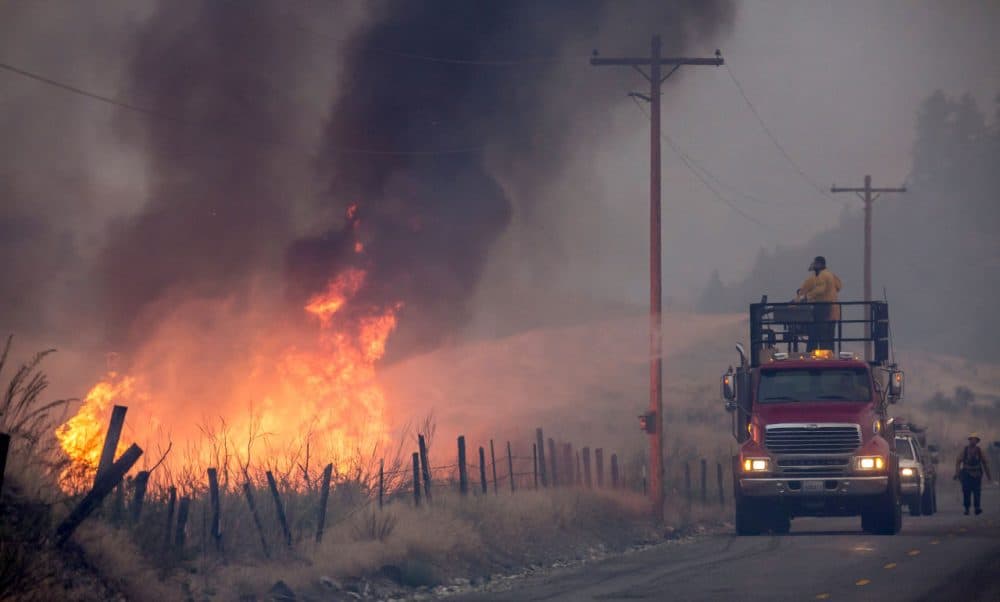 A makeshift fire truck puts water on a wildfire, which is part of the Okanogan Complex, as it burns through brush on August 22, 2015 near Omak, Washington. The fires have burned more than 127,000 acres. (Stephen Brashear/Getty Images)