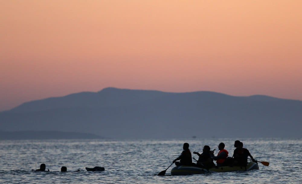 Two migrants from Syria are assisted by their friends as they swim the final 50 yards of their journey before arriving on the beach on the island of Kos after crossing a three mile stretch of the Aegean Sea in a small boat from Turkey August 28, 2015 in Kos, Greece. Migrants from the Middle East and North Africa continue to flood into Europe at a rate that marks the largest migration since World War II. (Win McNamee/Getty Images)