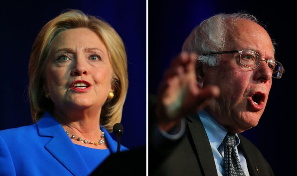 Democratic presidential candidates Hillary Clinton (left) and Bernie Sanders (right) are pictured speaking at the Democratic National Committee summer meeting on August 28, 2015 in Minneapolis, Minnesota. (Adam Bettcher/Getty Images)