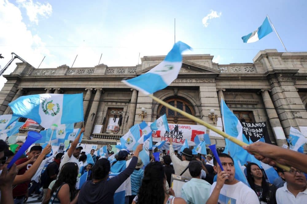 Guatemalans celebrate the recommendation from a legislative commission to revoke the presidential immunity of President Otto Perez Molina, in Guatemala City on August 29, 2015. The process against Perez Molina is similar to impeachment and could lead to criminal charges. (Orlando Sierra/AFP/Getty Images)