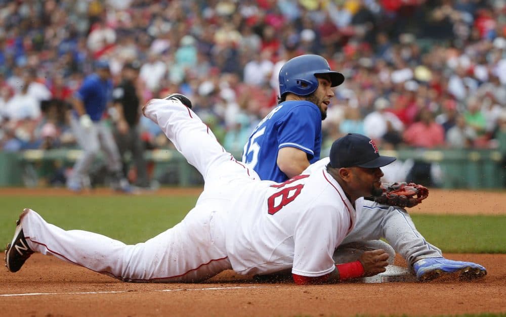 Kansas City Royals' Eric Hosmer and Boston Red Sox third baseman Pablo Sandoval look up after a throw got by Sandoval during the fourth inning of a baseball game at Fenway Park in Boston on Sunday, Aug. 23, 2015. (Winslow Townson/AP Photo)