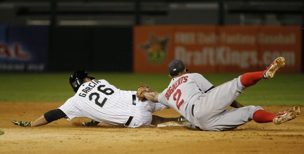 Boston Red Sox shortstop Xander Bogaerts, right, tags out Chicago White Sox's Avisail Garcia,left, at second, as Garcia tries to stretch his single to a double but slid past the base during the sixth inning of a baseball game Monday, Aug. 24, 2015, in Chicago. (Charles Rex Arbogast/AP Photo)