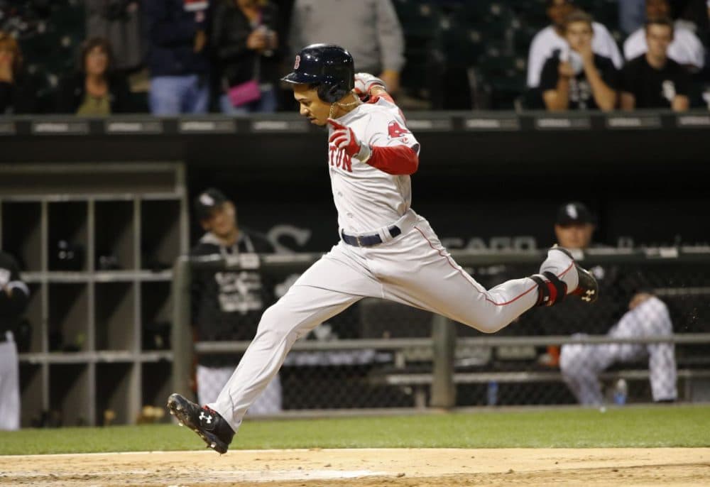 Boston Red Sox's Mookie Betts scores on his double and a throwing error by Chicago White Sox shortstop Alexei Ramirez, during the third inning of a baseball game Tuesday, Aug. 25, 2015, in Chicago. (Charles Rex Arbogast/AP Photo)