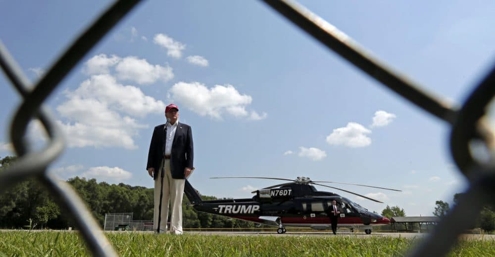 Republican presidential candidate Donald Trump  talks to the media after arriving by helicopter before attending the Iowa State Fair Saturday. (Charlie Riedel/AP)